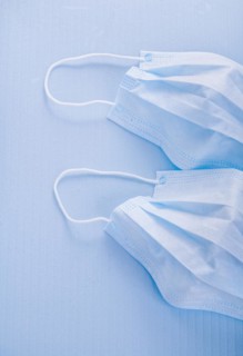 Disposable face masks on a blue background medical concept