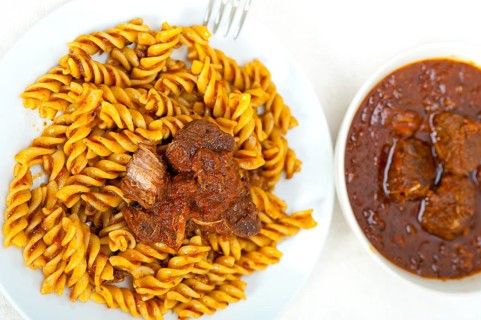 Fusilli pasta al dente with neapolitan style ragu meat sauce very different from bolognese style
