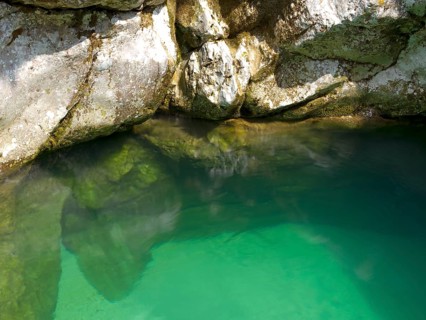 Emerald green Soca River with crystal clear water