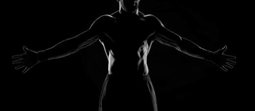 Noname image of a kickboxer on a dark background. The concept of mixed martial arts. MMA