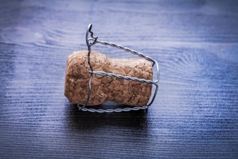 Close up corck of champagne and wire on board