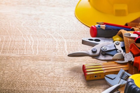 Organised copy room Hammer Tape measure Wrench Pliers Cutter Pencil in tool belt on wooden board