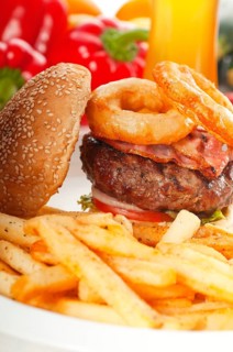 Classic american hamburger sandwich with onion rings and french fries