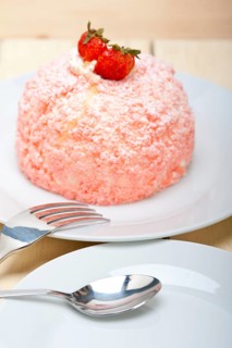 Fresh pink strawberry and whipped cream dessert macro close up