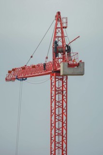 Professional crane operator inspecting the crane at high altitude