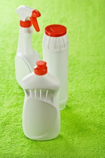 Three plastic bottles on a green background