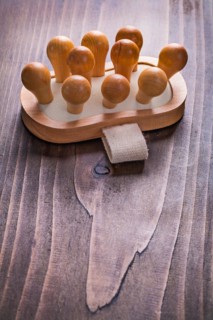 Classic wooden massager on vintage board