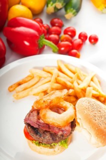 Classic american hamburger sandwich with onion rings and french fries