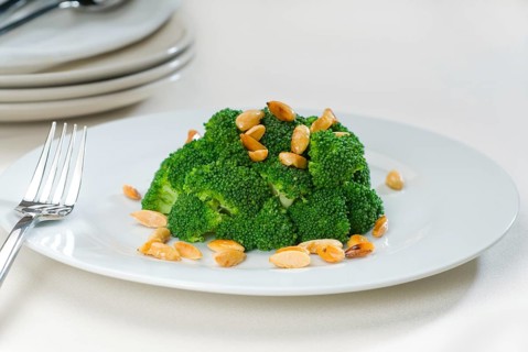 Fresh and vivid sauteed broccoli and almonds very ealthy food