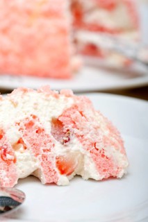 Fresh pink strawberry and whipped cream dessert macro close up