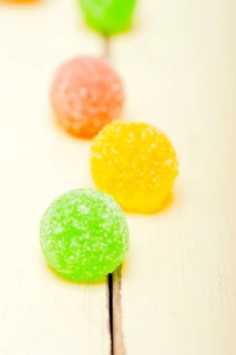 Sugar jelly fruit candy over white wood table