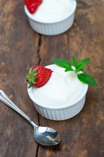 Organic Greek yogurt and strawberry on a rustic wood table