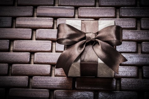 Giftbox on wooden wicker place mat holidays concept