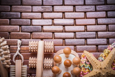 Group of bathing articles on textured wooden table mat healthcare concept