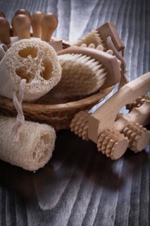 Peeling loofahs massage devices and nail brush on vintage wood background sauna concept