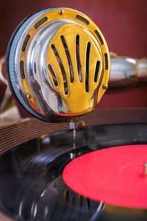 Gromophone speaker on vinyl disc close up