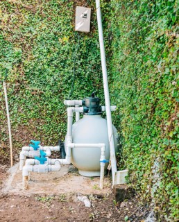 Pool purification and maintenance system. Home pool filter and treatment plant installed. Pool pump with sand filter installed