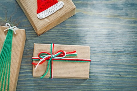 Assortment of handmade Christmas gift boxes on wooden board holidays concept