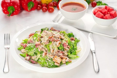 Fresh classic caesar salad served with gazpacho soup