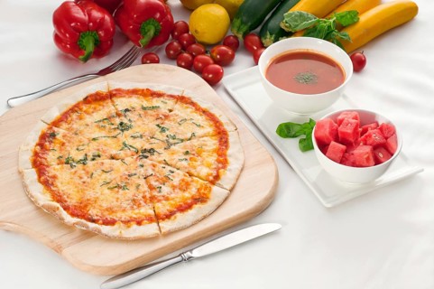 Italian original thin crust pizza Margherita with gazpacho soup and watermelon on side