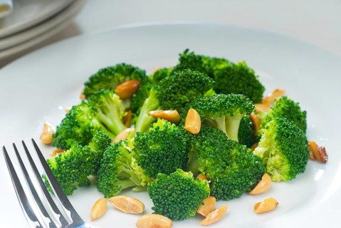 Fresh and vivid sauteed broccoli and almonds very ealthy food