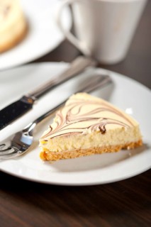 Fresh baked classic Cheese cake with chocolate topping and espresso coffee