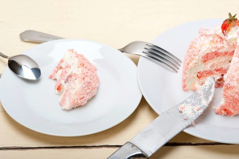 Fresh pink strawberry and whipped cream dessert macro close up