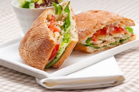 Italian ciabatta panini sandwich with chicken and tomato