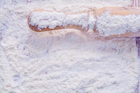 Copyspace photo handle of a wooden rolling pin with flour food and beverage concept horizontal version