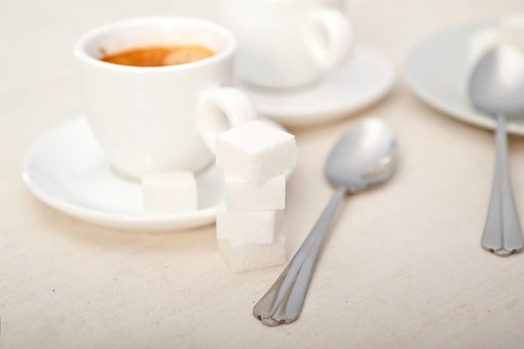 Italian espresso coffee fresh brewed macro closeup with sugar cubes