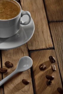 Coffee cup and spoon on wooden table