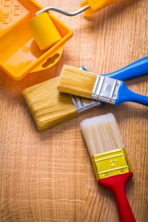 Compsition three brush roller and tray on wooden board