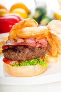 Classic american hamburger sandwich with onion rings and french fries