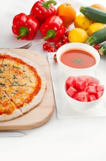 Italian original thin crust pizza Margherita with gazpacho soup and watermelon on side