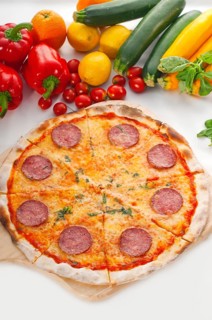 Italian original thin crust pepperoni pizza with fresh vegetables on background