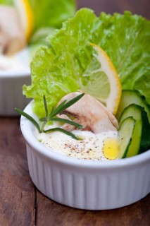 Fresh organic garlic cheese dip salad on a rustic table