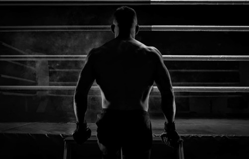 Kickboxer climbs into the ring. View from the back. Sports competitions. Fight night. The concept of mixed martial arts. MMA