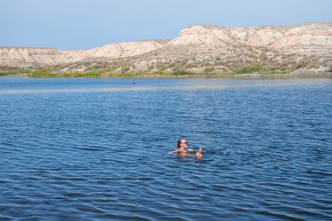Woman bathing in the Tuz Kul salt lake
