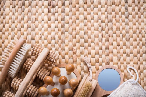 Horizontal view of sauna articles on a wicker mat Health concept