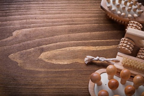 Helthcare background wooden sauna massager and nail brush on vintage board with copyspace
