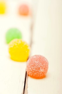 Sugar jelly fruit candy over white wood table