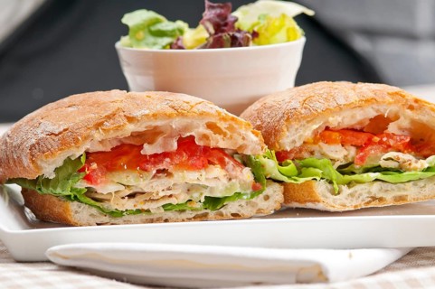 Italian ciabatta panini sandwich with chicken and tomato