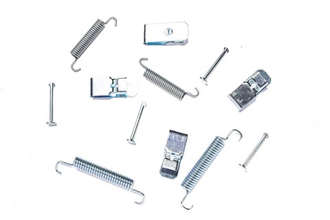 Repair kit of springs and clips for parking brake pads on white isolated background