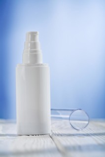 Single skin care sprayer on a white wooden table