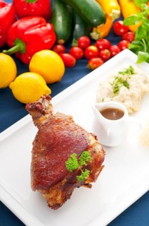 Original German BBQ pork knuckle served with mashed potatoes and sauerkraut