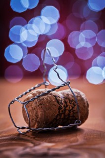 Champagne cork with wire on an old wooden table