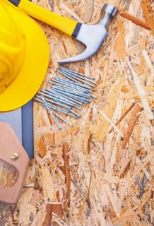 Construction tools Helmet Handsaw Claw hammer Nails on plywood