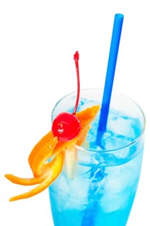 Blue long drink cocktail with orange and cherry garnish and blue straw