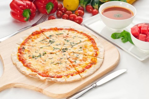 Italian original thin crust pizza Margherita with gazpacho soup and watermelon on side