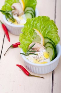 Fresh organic garlic cheese dip salad on a rustic table